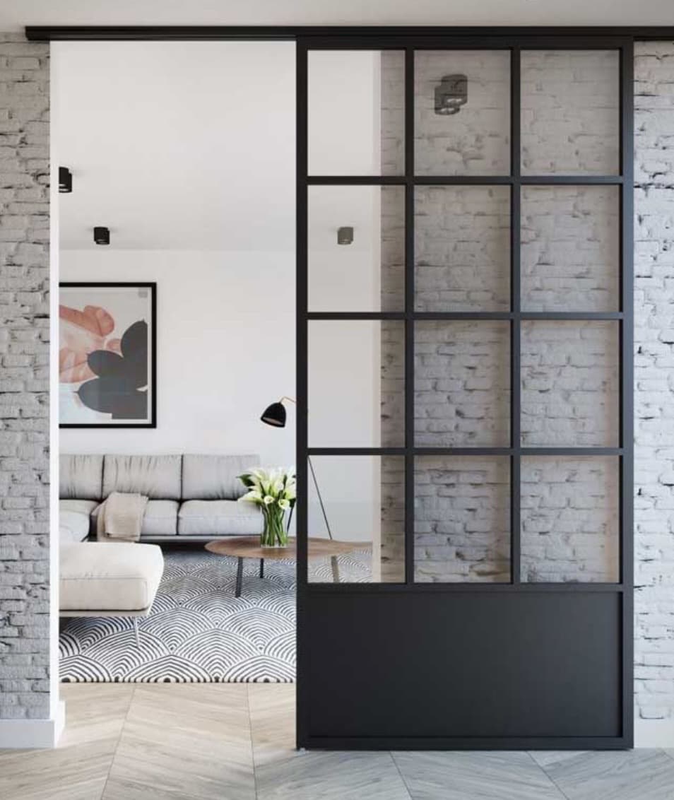 Black steel French-style sliding door with a grid of glass panes in a residential interior